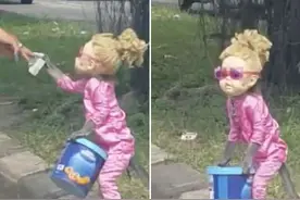 怪诞！印尼一猴子被打扮成洋娃娃路边表演乞讨图片