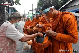 防疫有一套，泰国僧侣戴自制面罩去化缘图片