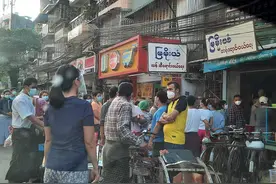 生活在缅甸仰光的华人：米店平时的大门是敞开的，但现在只开了一扇门，可能是担心一旦局势失控有人前来抢米图片