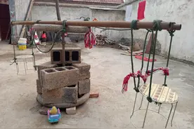 孩子宅在家憋闷，农民父亲用车轱辘做旋转木马，逗俩娃开心图片