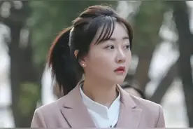 小姐姐身穿粉色长款西服，内搭白色立领衬衫，秀出好身材图片