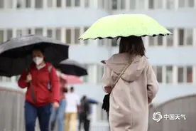 北京雨水飘落秋意浓 街头市民换厚装撑伞出行图片
