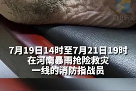 消防指战员们脱下渗进泥水的雨靴，双脚早已被积水泡得浮肿图片