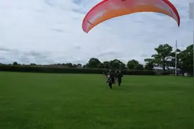英国一名2岁小女孩和父亲一起乘滑翔伞在200米高空飞翔图片