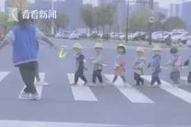 幼儿园老师拉绳子保护萌娃过马路 网友：萌化了图片
