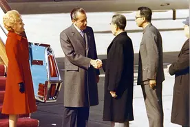 1972年尼克松访华时，亲自为总理脱去大衣，在饭桌上使用筷子图片