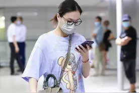 35岁的吴敏霞皮肤白皙，穿浅蓝色T恤配杏色长裤，显得非常温柔图片