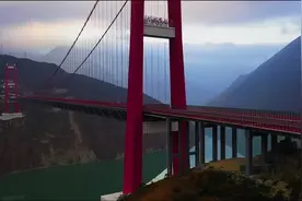 航拍中国四川甘孜藏族自治州泸定县雪山下的兴康特大桥视频封面