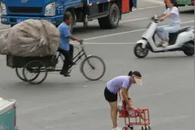 年轻母亲推着几个月大的婴儿穿梭在车来车往没有斑马线的十字路口视频封面