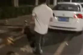 男子正往车上粘贴“涉黄小卡片”，被民警抓个正着图片