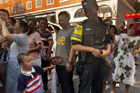 考点外的清凉温馨一幕 考生幼弟为护考特警扇扇子图片